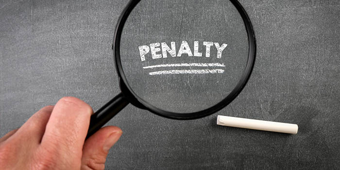 Magnifying glass focuses on the word "penalty"