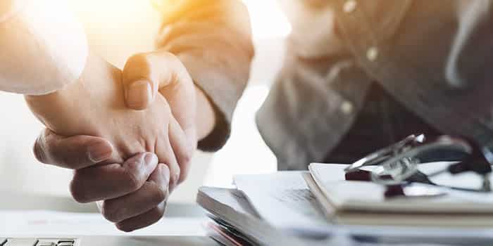 Two businessmen shake hands