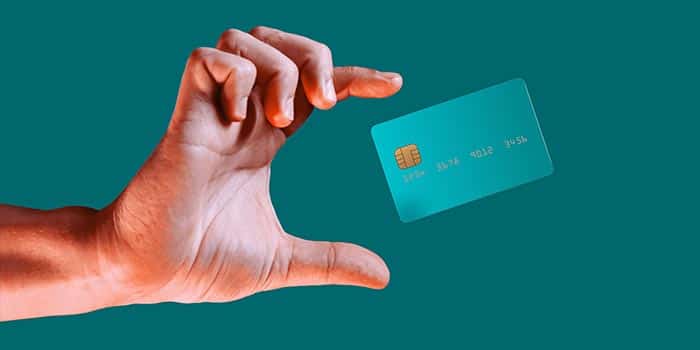 A hand reaches out to a credit card