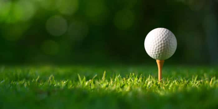 Golf ball on green field