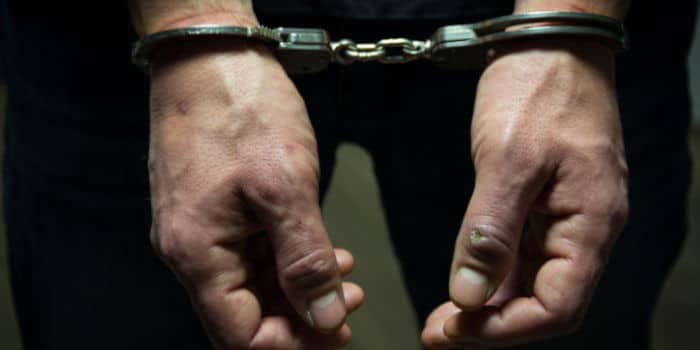 A person's hands in handcuffs