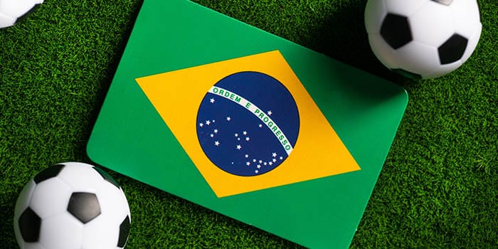 Soccer balls next to Brazil's flag