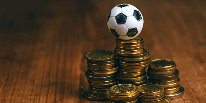 A soccer ball on a pile of coins