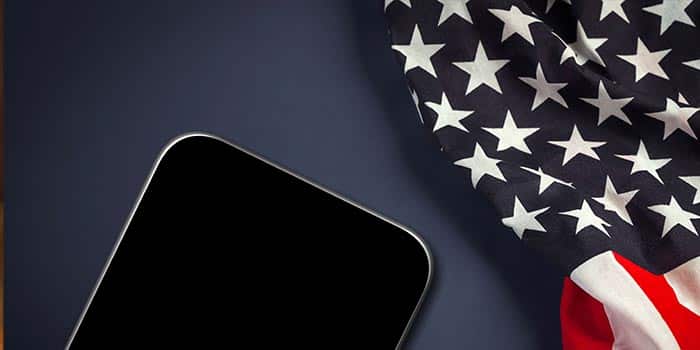 A mobile device next to the US flag