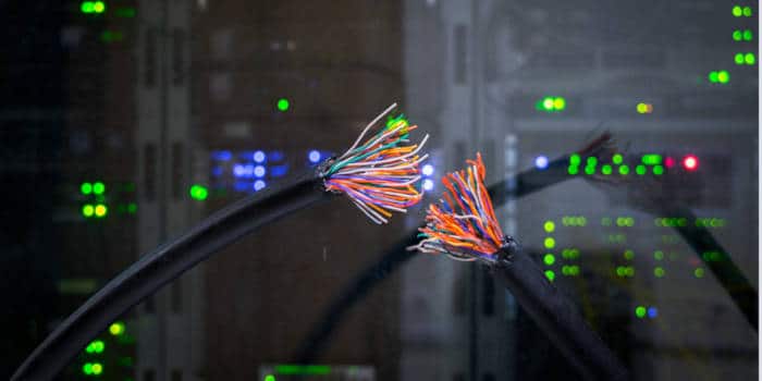 A severed cable next to a computer server.