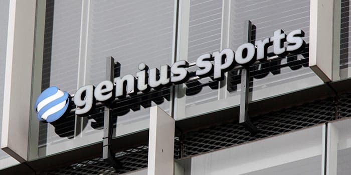 Genius Sports' official logo on a building.