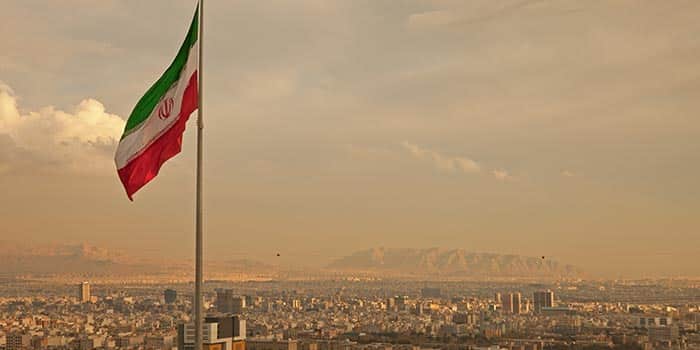 Iran's flag on a sandy day