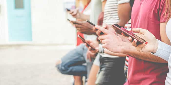 A group of teenagers on their phones