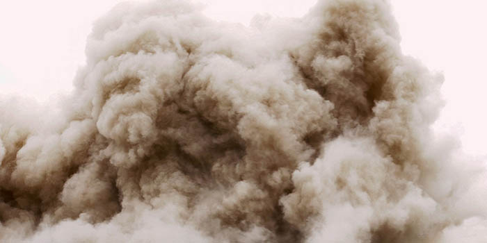 A cloud of dust caused by the demolition of a building