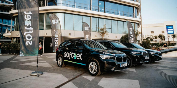 Soft2Bet-branded cars parked before the company's office