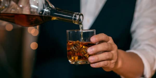 news-bartender-pouring-whisky-into-a-glass