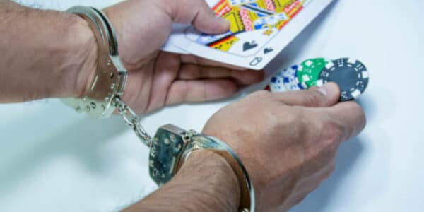 news-hands-in-handcuffs-illegal-gambling