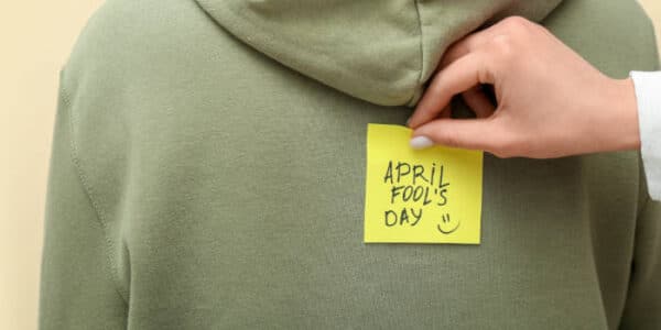 news-woman-sticking-a-note-april-fools-day