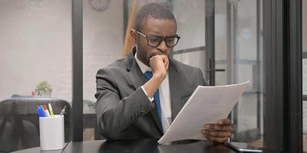 person-businessman-reads-document-news