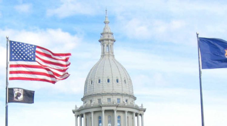 Michigan's Senate with the state and national flags outside.