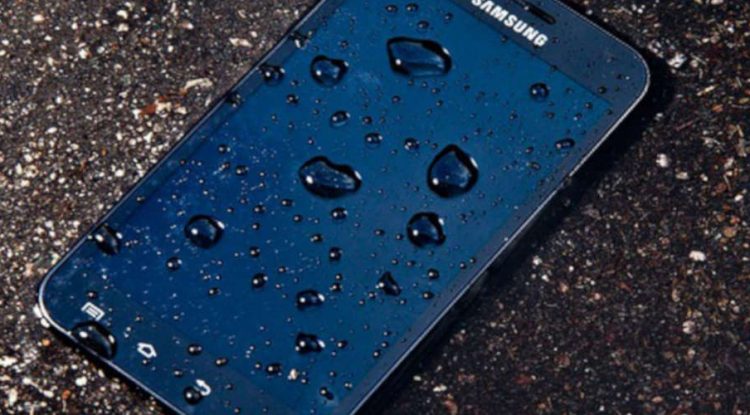 A phone left on the pavement in the rain.