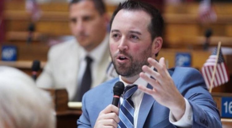 Shawn Fluharty speaking in front of legislators.